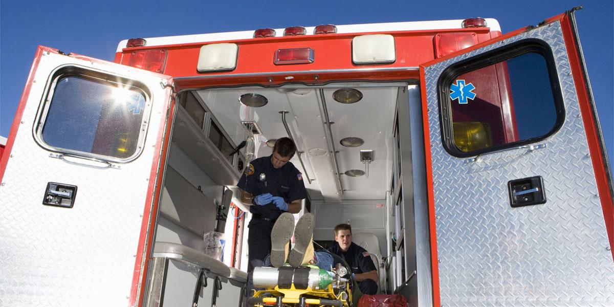 Emergency medical technicians in the back of an ambulance